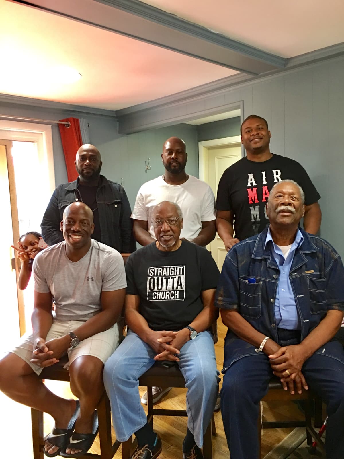Rev. English seated with the men of the family gathered around him